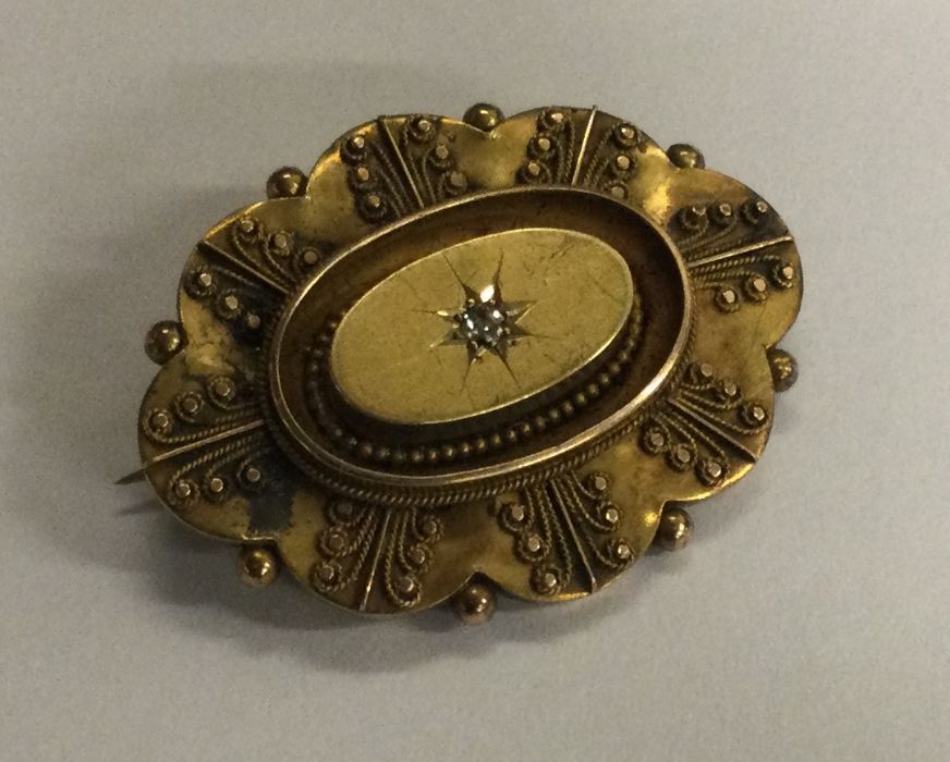 A 15 carat gold diamond target brooch. Approx. 5.4