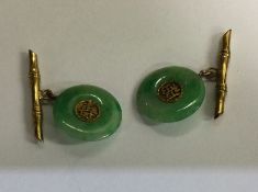 A pair of circular jade cufflinks. Approx. 4 grams