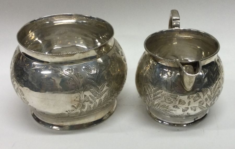 An engraved Victorian aesthetic movement silver sugar and cream. Birmingham 1887. By H Bros. Approx. - Image 2 of 2