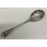 A chased silver serving spoon embossed with flowers. Sheffield 1902. By James Deakin and Sons.