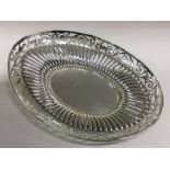 An oval silver half fluted fruit bowl with pierced