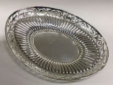 An oval silver half fluted fruit bowl with pierced