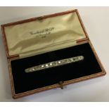 A good diamond single row brooch of tapering form.