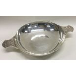 A large silver quaich with embossed handles. London 1947.By Wakely and Wheeler. Approx. 348 grams.