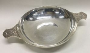 A large silver quaich with embossed handles. London 1947.By Wakely and Wheeler. Approx. 348 grams.