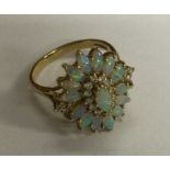 A good quality opal and diamond cluster ring in 18