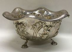 A Victorian silver chased fruit bowl on feet with bright cut engraved border. London 1850. By Robert