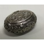 A Continental hinged silver box with chased decoration. Approx. 53 grams. Est. £40 - £60.