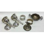 A collection of silver napkin rings, spill vases e