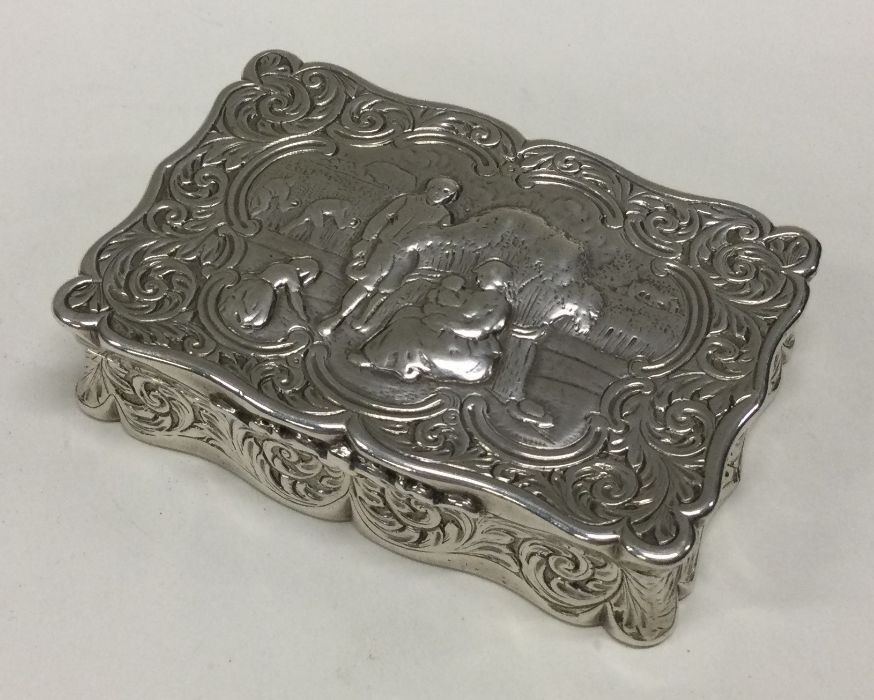 A Victorian Dutch silver chased silver hinged snuff box bearing import marks. Approx. 139 grams.