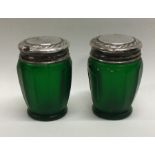 A pair of silver mounted green glass jars. Birmingham 1926. Est. £20 - £30.
