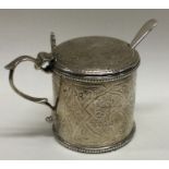 A Victorian silver mounted engraved glass mustard pot. London 1875. By Joseph Walton. Approx. 84