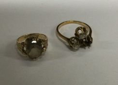 A small gold single stone ring together with one o