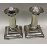 A good pair of silver dwarf candlesticks on square
