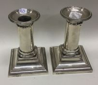 A good pair of silver dwarf candlesticks on square