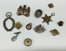 Old Military cap badges, silver pendants etc. Est.