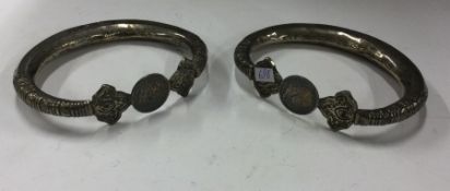 A pair of heavy Continental silver slave bangles.