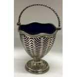A George III silver mounted cranberry glass swing handled basket with pierced decoration. Maker’s