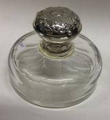 A Victorian silver mounted glass scent bottle/inkwell embossed with cherubs. London 1896. By William