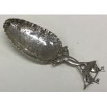 A Dutch silver scoop decorated with a boat. Approx