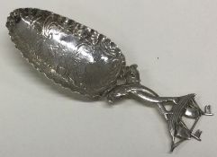 A Dutch silver scoop decorated with a boat. Approx