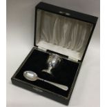 A cased silver egg cup and spoon. Birmingham 1957. Approx. 58 grams. Est. £50 - £80.