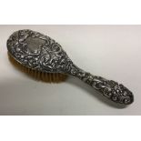 A Victorian silver chased brush. Birmingham 1897. Approx. 202 grams. Est. £30 - £50.
