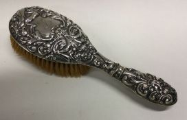 A Victorian silver chased brush. Birmingham 1897. Approx. 202 grams. Est. £30 - £50.