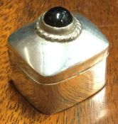 A silver hinged box with stone inset. Marked to interior. Approx. 19 grams. Est. £15 - £20.