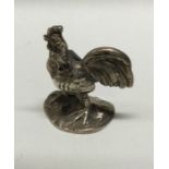 A silver figure of a cockerel bearing import marks. Approx. 29 grams. Est. £60 - £80.