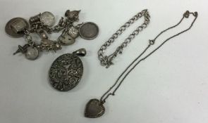 A silver charm bracelet, locket etc. Approx. 106 g