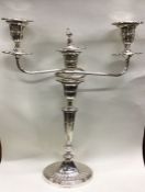 A heavy silver three branch candelabra of tapering