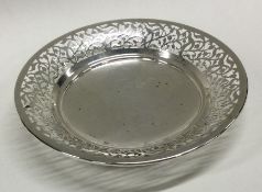 A circular silver bonbon dish with pierced decorat