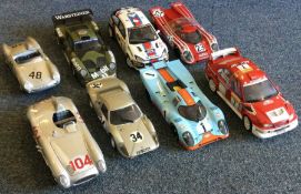 Nine 1:18 scale unboxed model racing cars. Est. £2