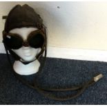 A vintage leather race hat and goggles. Est. £40 -