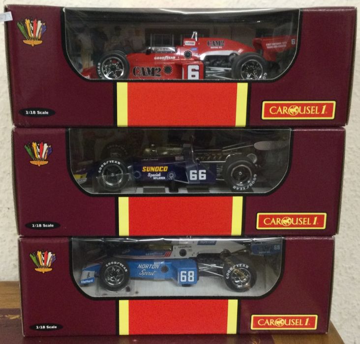 CAROUSEL: Three boxed 1:18 scale model racing cars