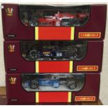 CAROUSEL: Three boxed 1:18 scale model racing cars