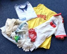 A collection of various race team shirts, gloves e