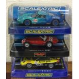 SCALEXTRIC: Three boxed model racing cars. Est. £2