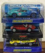 SCALEXTRIC: Three boxed model racing cars. Est. £2