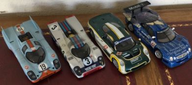 Four 1:18 scale unboxed model racing cars. Est. £2