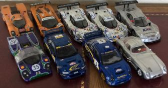 Nine 1:18 scale unboxed model racing cars. Est. £2