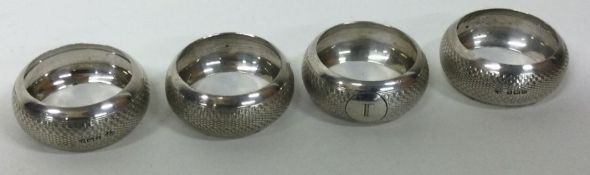 A set of four silver napkin rings. Birmingham. Approx. 65 grams. Est. £25 - £35.