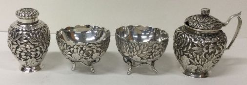 A fine and unusual four piece Japanese silver embossed condiment set marked.