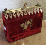 A red velvet mounted box set with perfume bottles.
