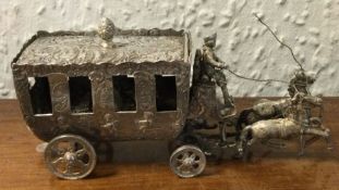 A large silver table toy in the form of a carriage
