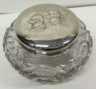 A large silver mounted glass jar with cherub decoration. Birmingham 1907. By Henry