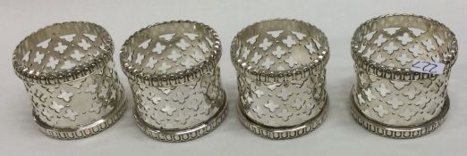 A heavy set of four pierced silver napkin rings. A