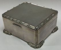 A stylish silver hinged top cigarette box with bal