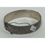 A heavy silver bracelet with engraved decoration. Approx. 50 grams. Est. £20 - £30.